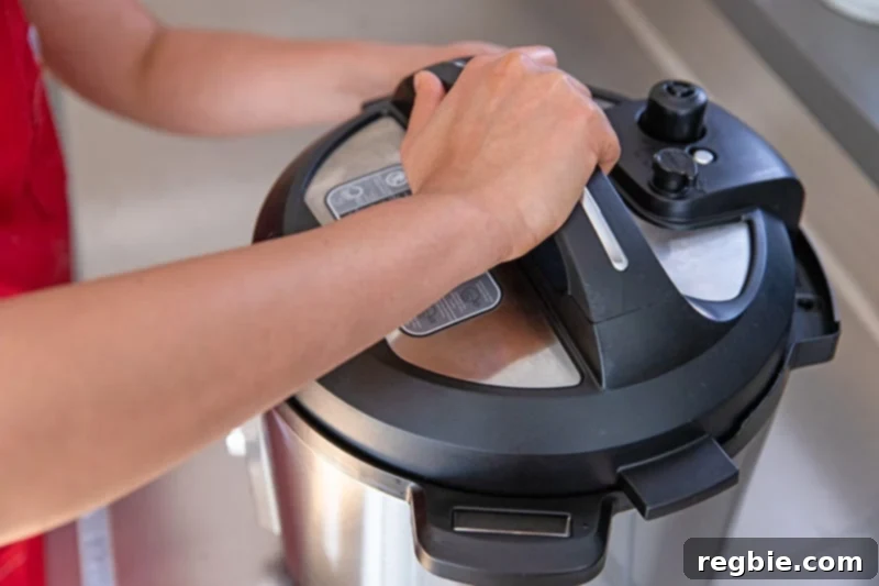 Someone locking the lid on an Instant Pot to make Instant Pot butternut squash soup.