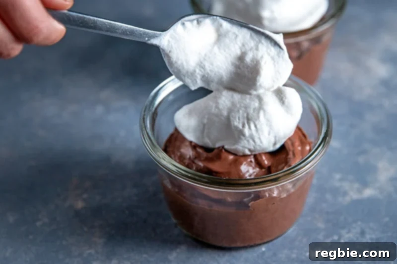 Heavenly Paleo Chocolate Pudding 11 A finished bowl of paleo chocolate pudding topped with whipped coconut cream and chocolate shavings.