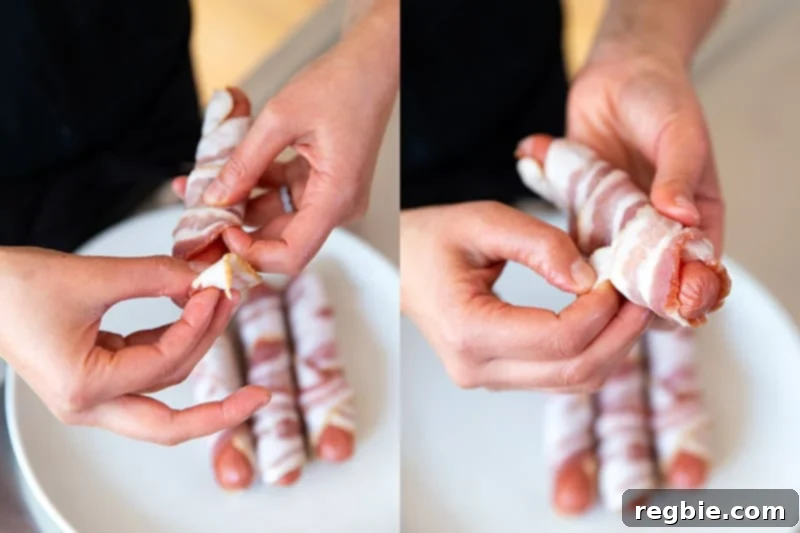 Wrapping a piece of bacon around a hot dog to make Whole30, keto, and paleo Sonoran hot dogs and tucking the ends of the bacon under the rest of the bacon to keep it in place.