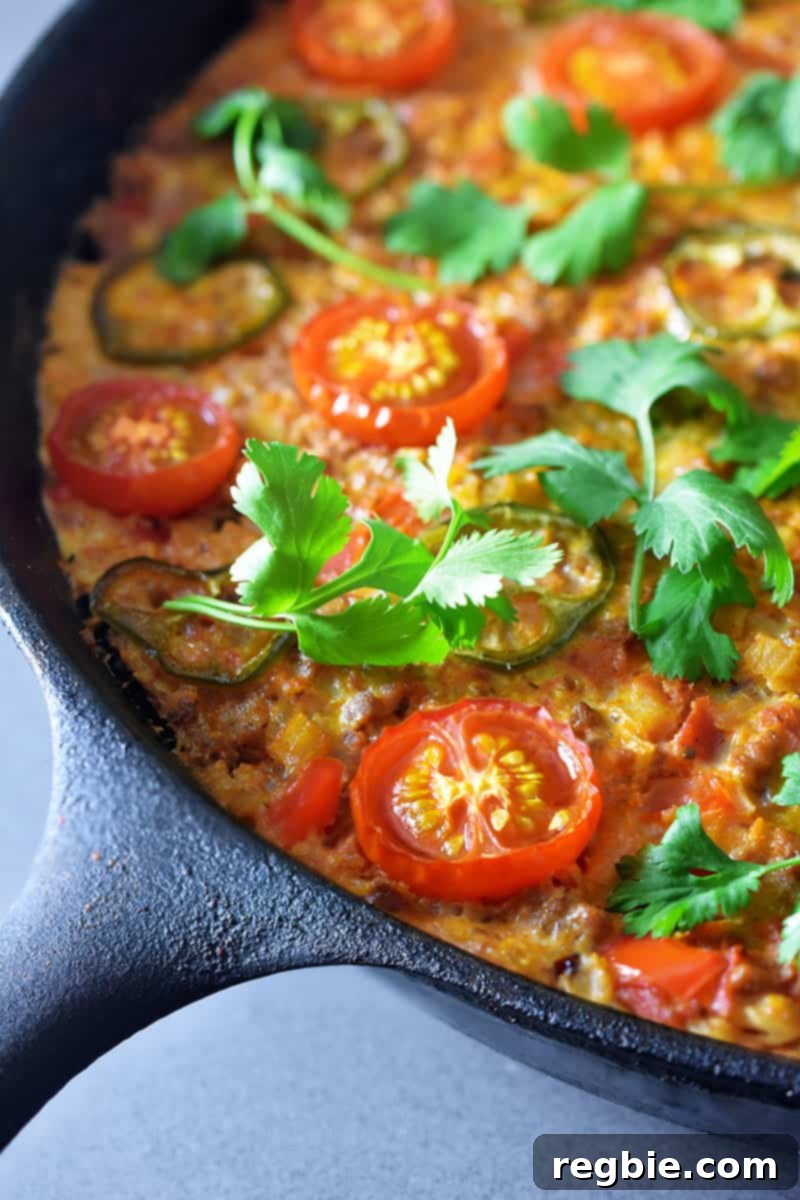 A closeup shot of Tex-Mex Beef and Rice Casserole, a Whole30-friendly one pan meal that you can make in a cast iron skillet.
