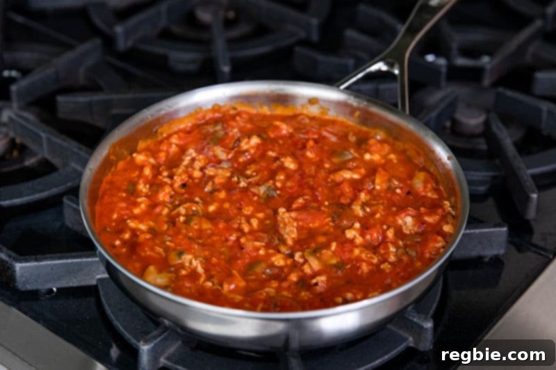 Inferno Eggs 10 A skillet filled with spicy meat sauce for eggs in purgatory.