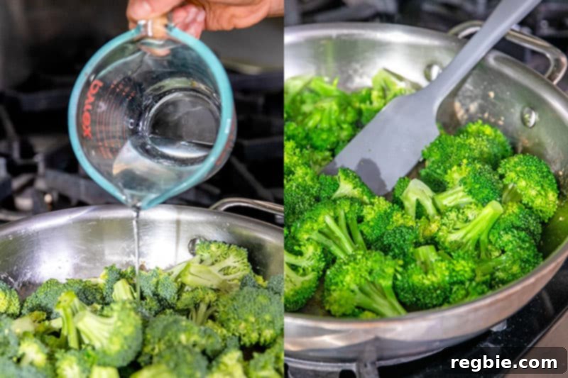 Pouring water into a stainless steel skillet already filled with fresh broccoli florets, preparing them for steaming.