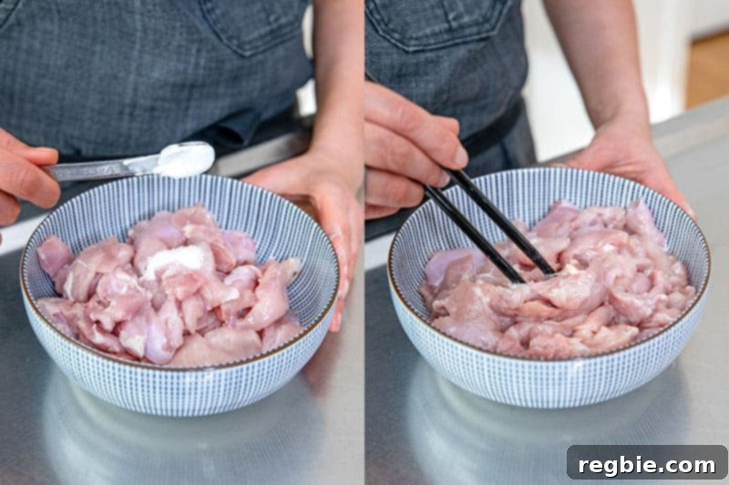 A close-up of a person adding arrowroot powder to sliced raw chicken thigh meat in a bowl and stirring it with a pair of black chopsticks to marinate.