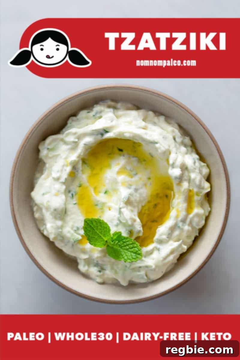 An overhead shot of a shallow beige bowl filled with dairy-free vegan, Whole30, keto, and paleo Tzatziki, garnished with fresh dill and a drizzle of olive oil.