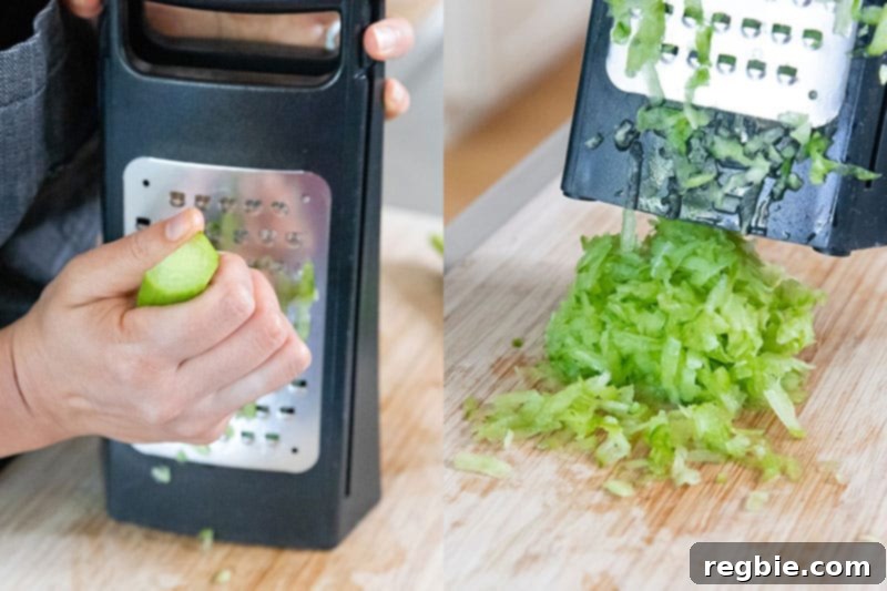Grating the peeled and seeded cucumber on the large holes on a box grater. 