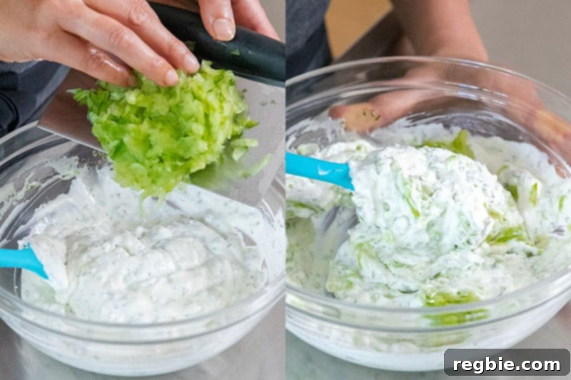 Adding the drained and diced cucumbers to the vegan tzatziki base.