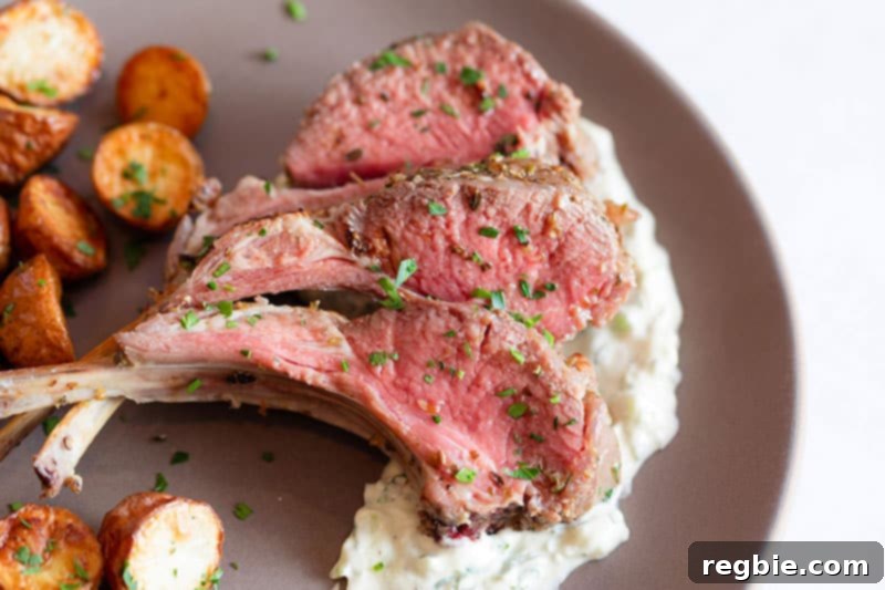 A closeup shot of Whole30 rack of lamb with dairy-free Tzatziki Sauce.