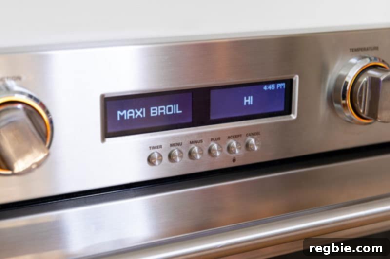 A close-up view of a wall oven display showing 'MAXI BROIL', indicating the oven is set to its highest broiling temperature.