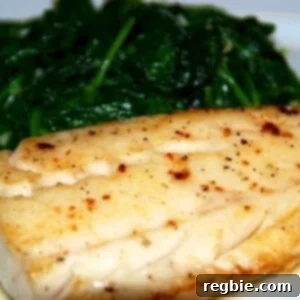 Paleo and Whole30 easy sous vide wild alaskan cod on a plate with steamed spinach.