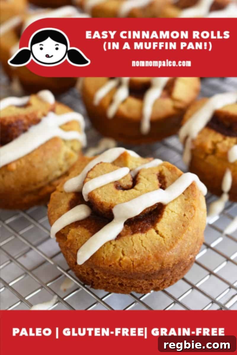 A closeup of a perfectly baked paleo cinnamon roll, golden brown and glistening with a smooth glaze, cooling on a wire rack. The image highlights its gluten-free and grain-free qualities, emphasizing a healthy indulgence.