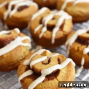 A closeup of a paleo cinnamon roll on a wire rack.