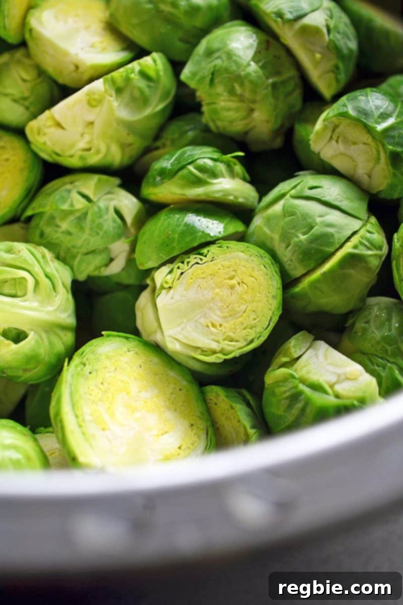 Cleaned and trimmed Brussels sprouts, halved and ready to be cooked.