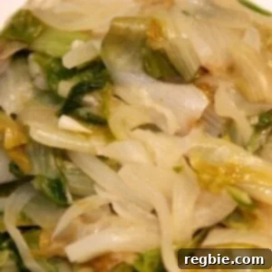 Caramelized Onion Escarole Braise 2 Paleo and Whole30 braised escarole with onions on a plate.