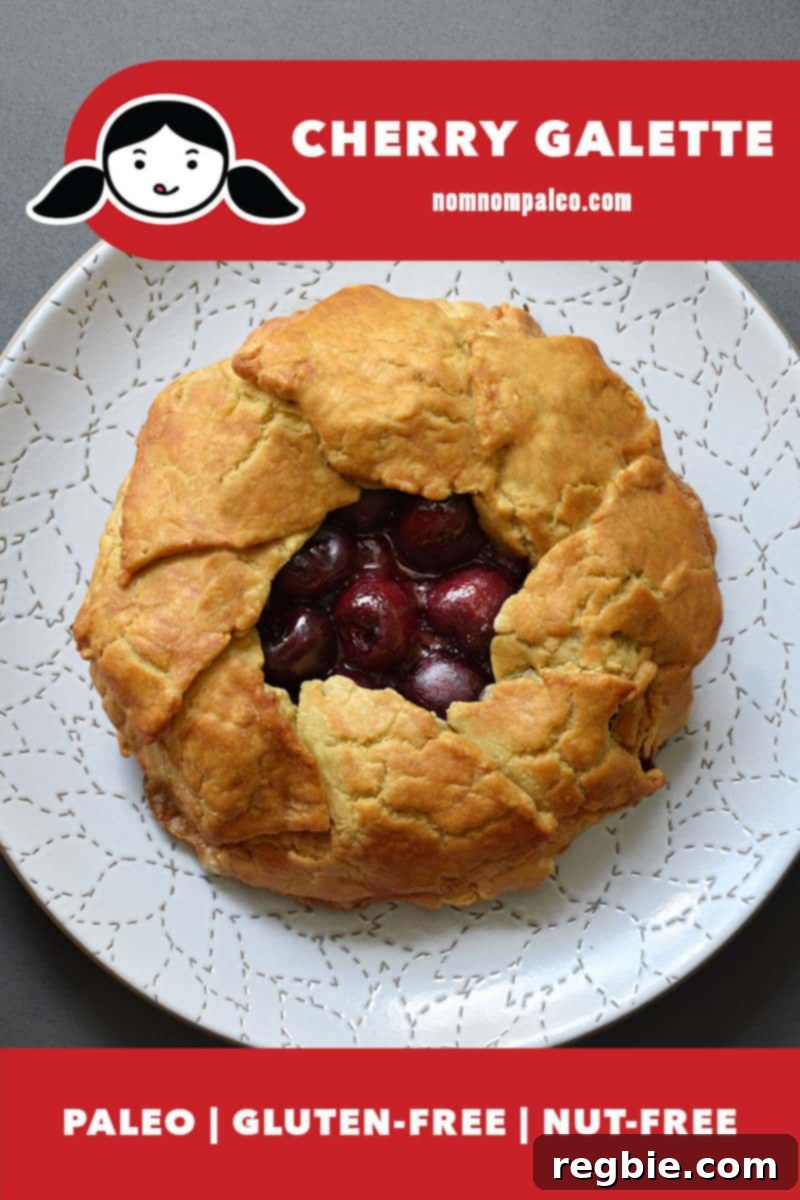 An overhead shot of a paleo cherry galette on top of a white plate. There is a red banner at the bottom that states that it is paleo, gluten-free, and nut-free.