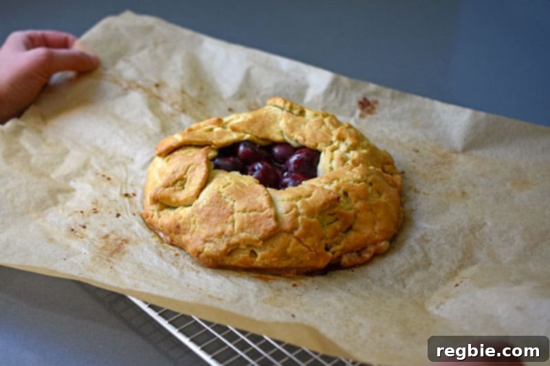 Placing the paleo cherry galette onto a wire cooling rack.