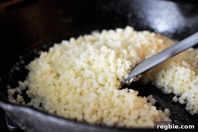 Effortless Cauliflower Rice 8 Stir-frying Simple Cauliflower Rice in a cast iron skillet
