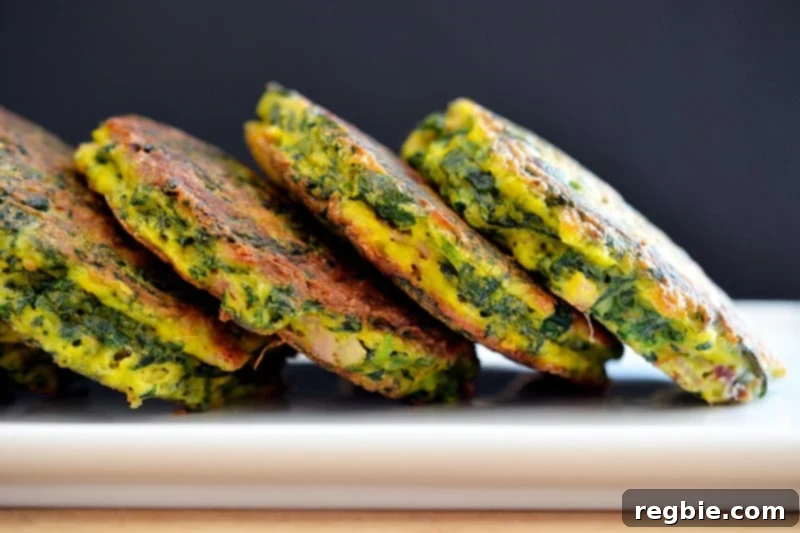 Four paleo egg foo young patties arranged neatly on a white plate, ready for assembly.
