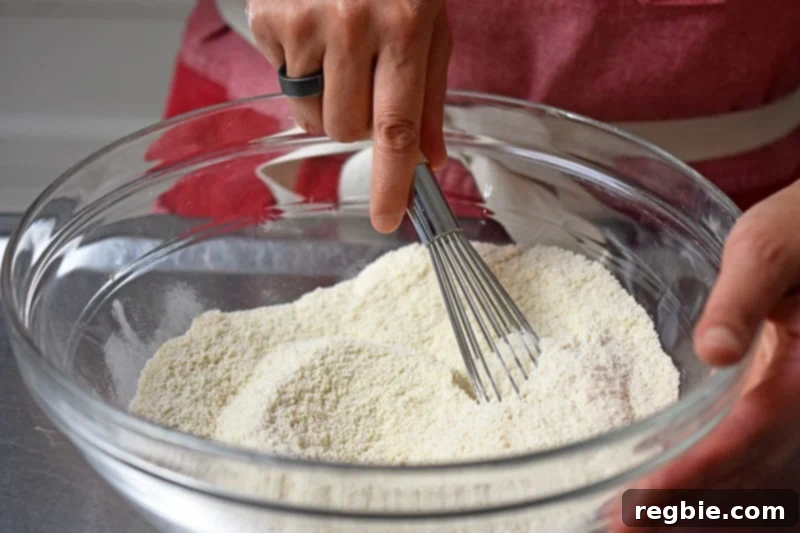 Whisking the dry ingredients for a paleo and gluten free berry snack cake.