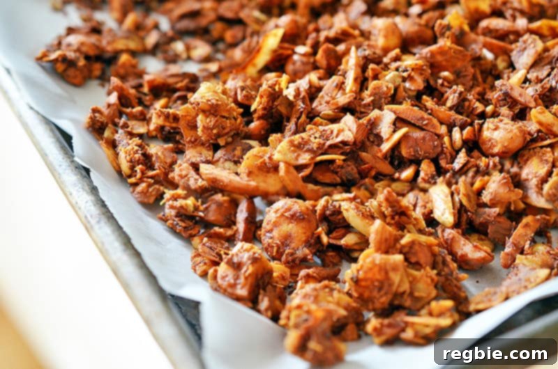 A closeup of a tray of paleo tropical granola fresh out of the oven, packed with fruity and nutty flavors.