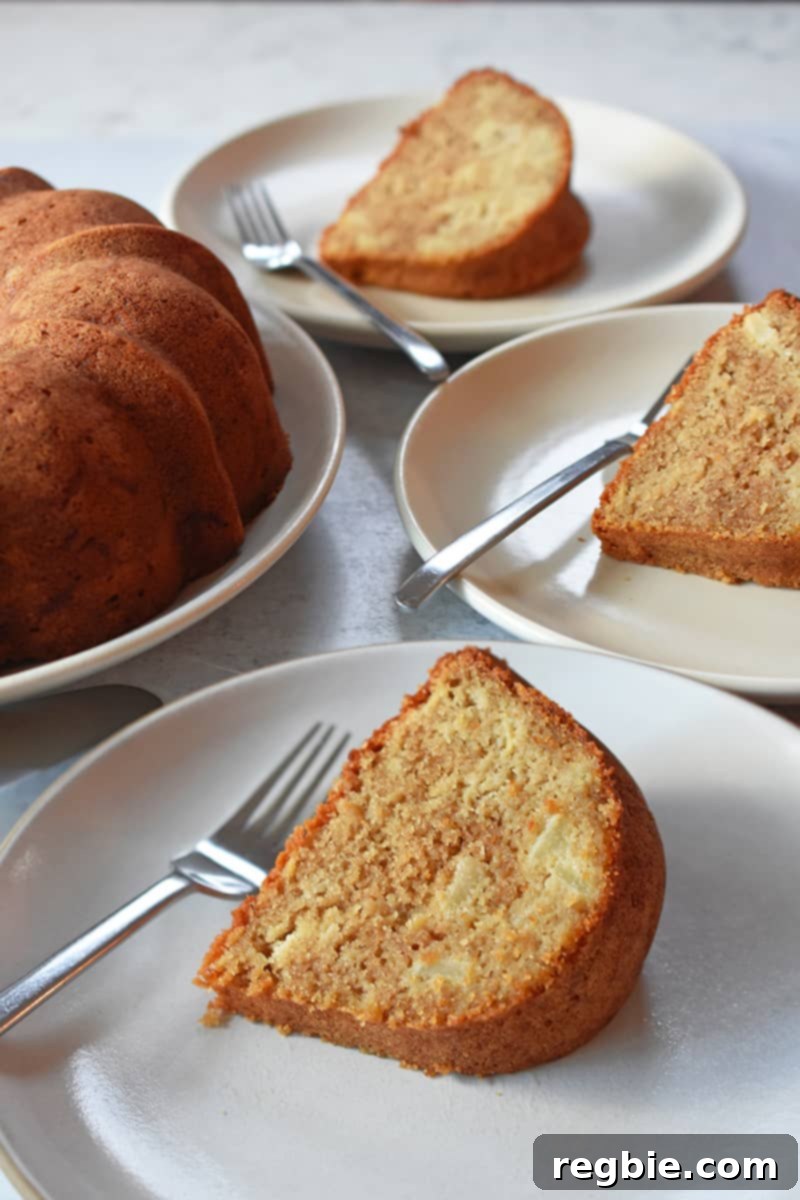 Grain Free Spiced Apple Bundt Cake 3 A close-up shot of three delicious slices of Paleo Apple Bundt Cake arranged on white plates with forks, next to the main cake.
