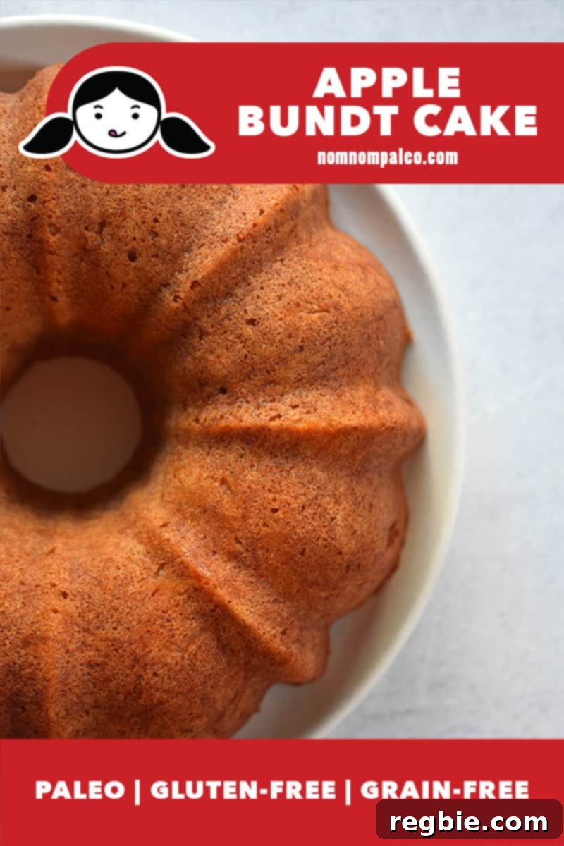 Grain Free Spiced Apple Bundt Cake 4 An inviting overhead shot of a freshly baked Paleo Apple Bundt Cake, served without any glaze, showcasing its golden-brown crust. A red banner at the bottom confirms its paleo, gluten-free, and grain-free nature.