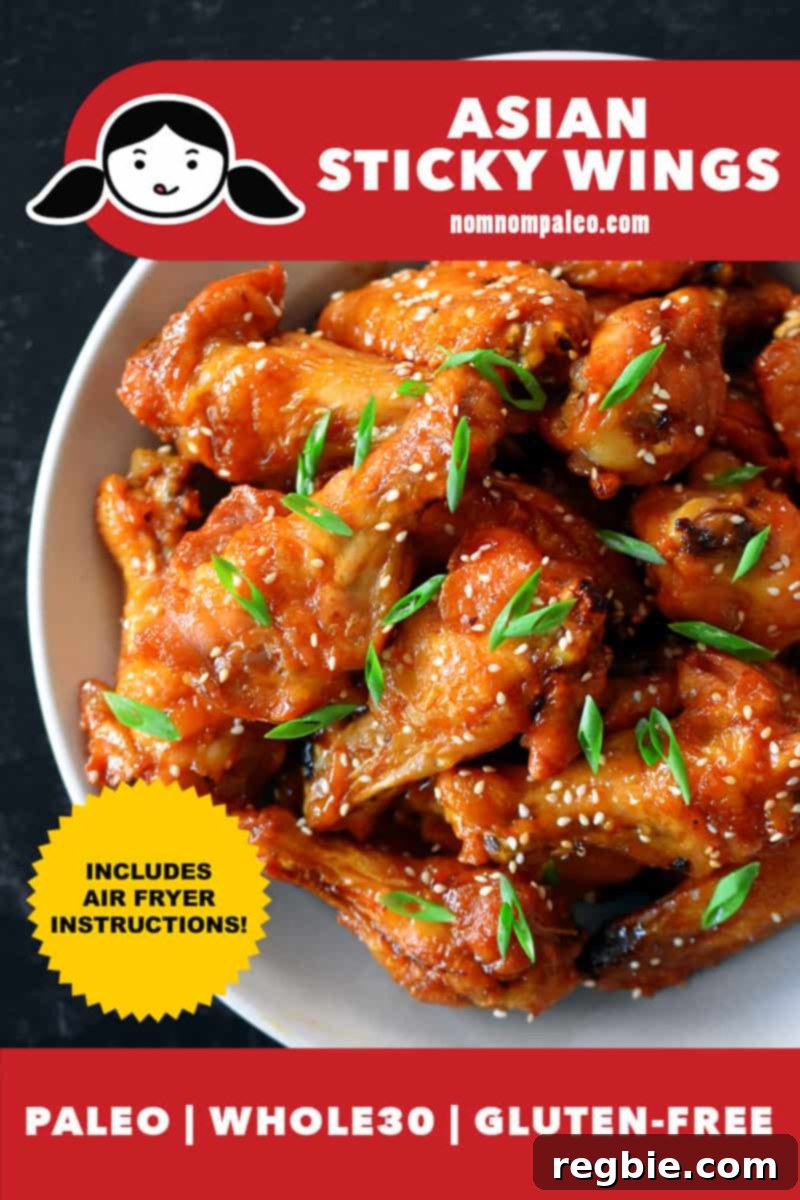 An overhead shot of a generous bowl of glistening Asian chicken wings, perfectly coated in a sticky sauce and garnished with sesame seeds and green onions. A red banner at the bottom highlights their paleo, Whole30, and gluten-free status, while a yellow badge indicates air fryer instructions are included.
