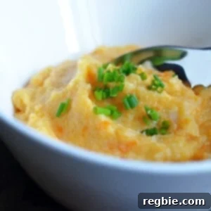 Roasted Garlic Autumn Root Vegetable Mash by Michelle Tam https://nomnompaleo.com. A rustic, colorful mash in a serving bowl, perfectly garnished.