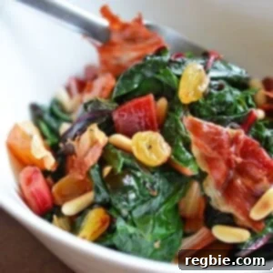 Swiss Chard with Raisins, Pine Nuts, and Porkitos by Michelle Tam / Nom Nom Paleo https://nomnompaleo.com. A rustic, vibrant dish of cooked chard with crispy pork bits.