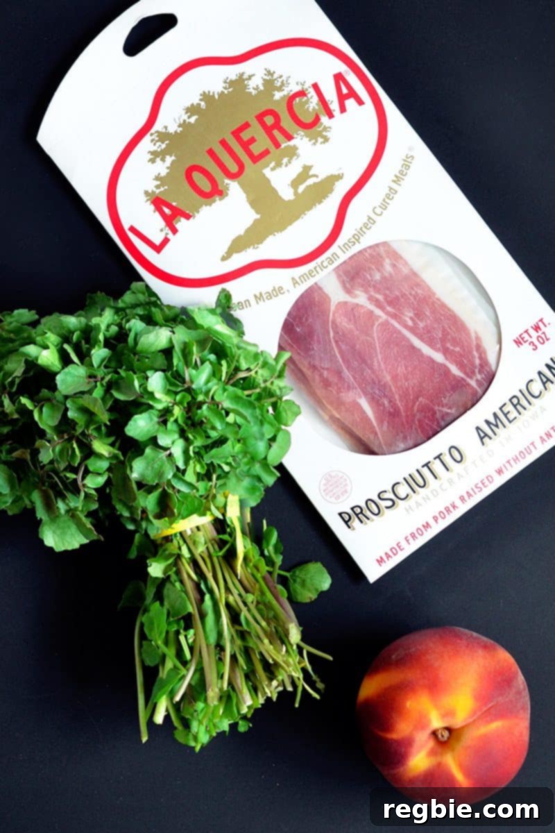 Prosciutto, watercress, and a peach sitting on a counter for the Watercress with Seared Prosciutto and Peaches recipe.