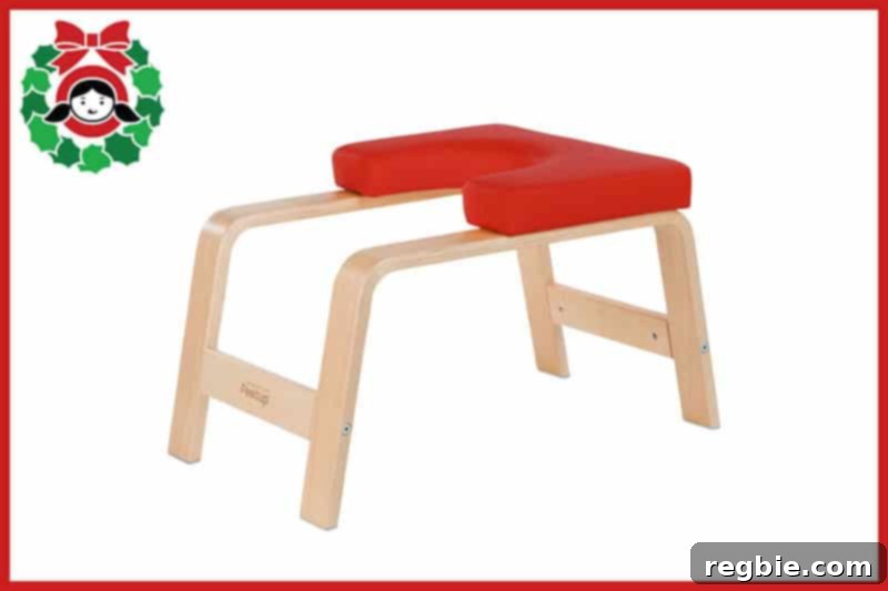 A red FeetUp inversion chair, designed to facilitate safe and accessible inversion yoga postures.