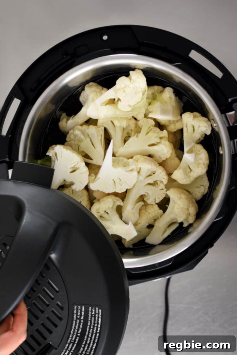 Garden Colcannon 4 An overhead shot of an open Instant Pot filed with cauliflower florets in a streamer.