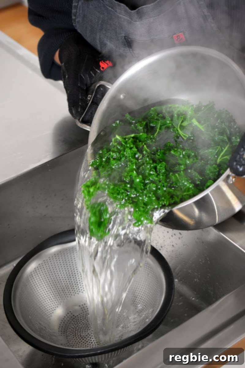 Garden Colcannon 8 Pouring blanched kale from a stockpot into a colander in a sink.
