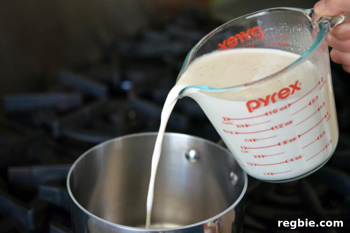 Pouring the Panna Cotta mixture into a saucepan.