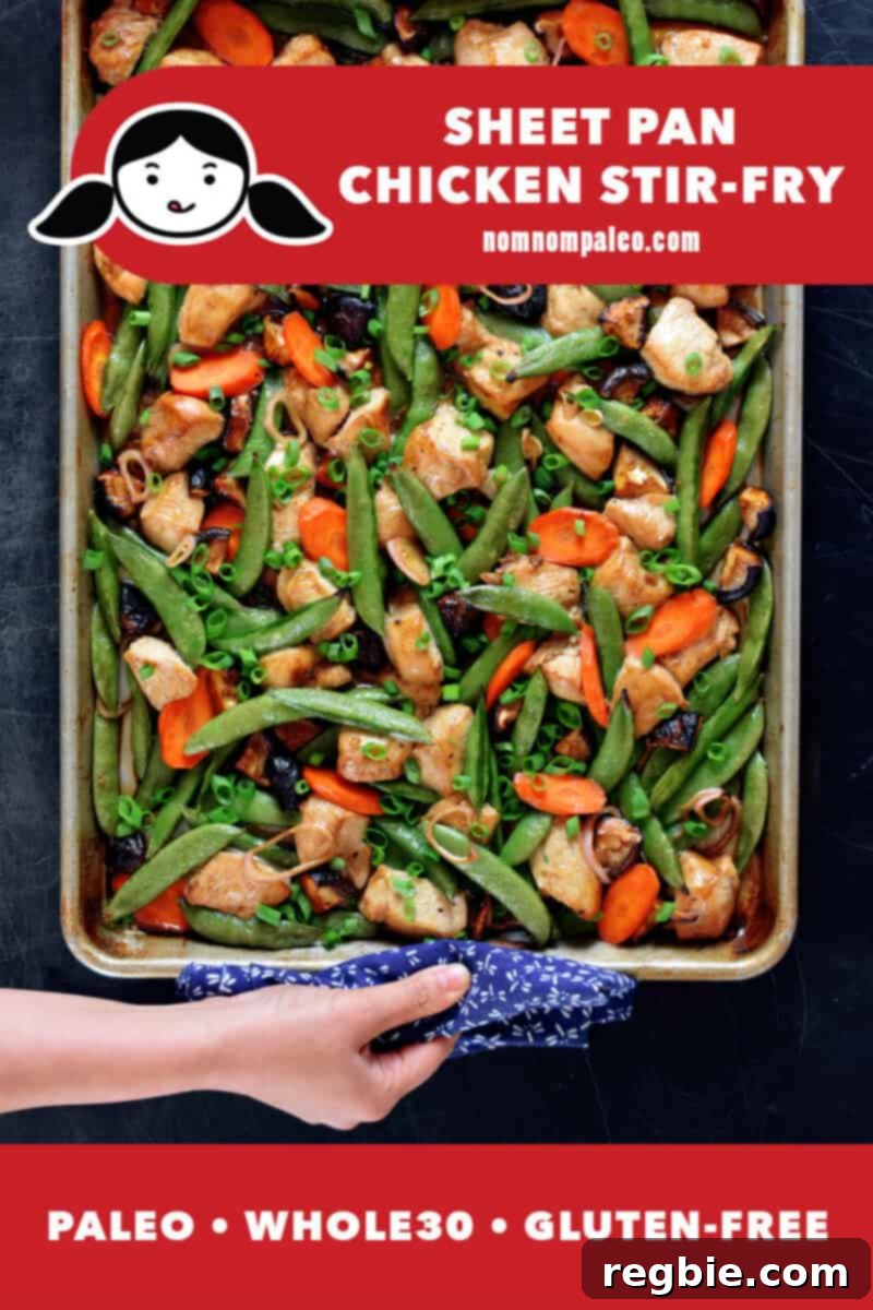 One-Pan Wonder Chicken Stir-Fry 2 An overhead shot of sheet pan chicken stir-fry fresh out of the oven. A hand is holding the edge of the pan with a towel. The red banner at the bottom reads paleo, Whole30, gluten-free.