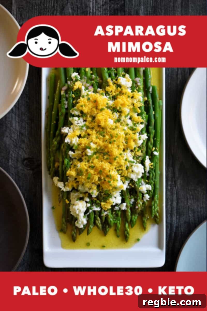 Whole30 Keto Paleo Asparagus Mimosa 2 An overhead shot of asparagus mimosa on a rectangular platter, blanched asparagus topped with a zesty vinaigrette and sieved hard boiled eggs. The red banner on the bottom says paleo, Whole30, and keto.