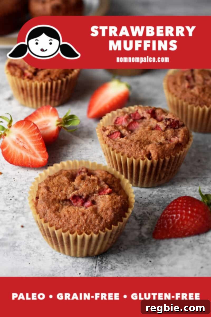 Deliciously baked strawberry muffins on a elegant marble countertop, adorned with fresh, vibrant sliced strawberries. A red banner clearly labels them as paleo, grain-free, and gluten-free.