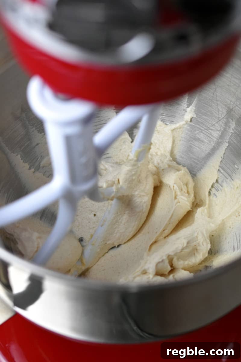 The mixture of ghee and maple sugar has been expertly whipped to a light, cream-colored, and wonderfully fluffy consistency, indicating proper aeration.