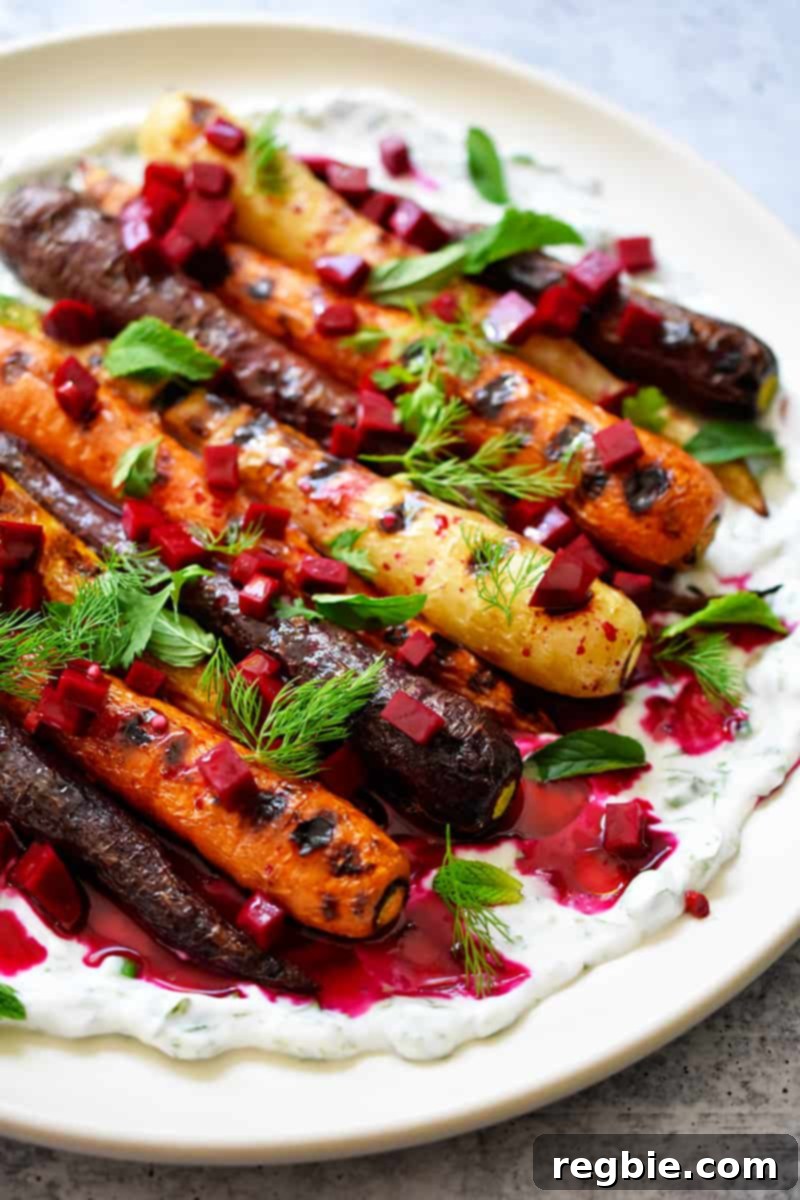 A closeup side shot of Grilled Carrots with Herby Coconut Yogurt and a spicy beet vinaigrette
