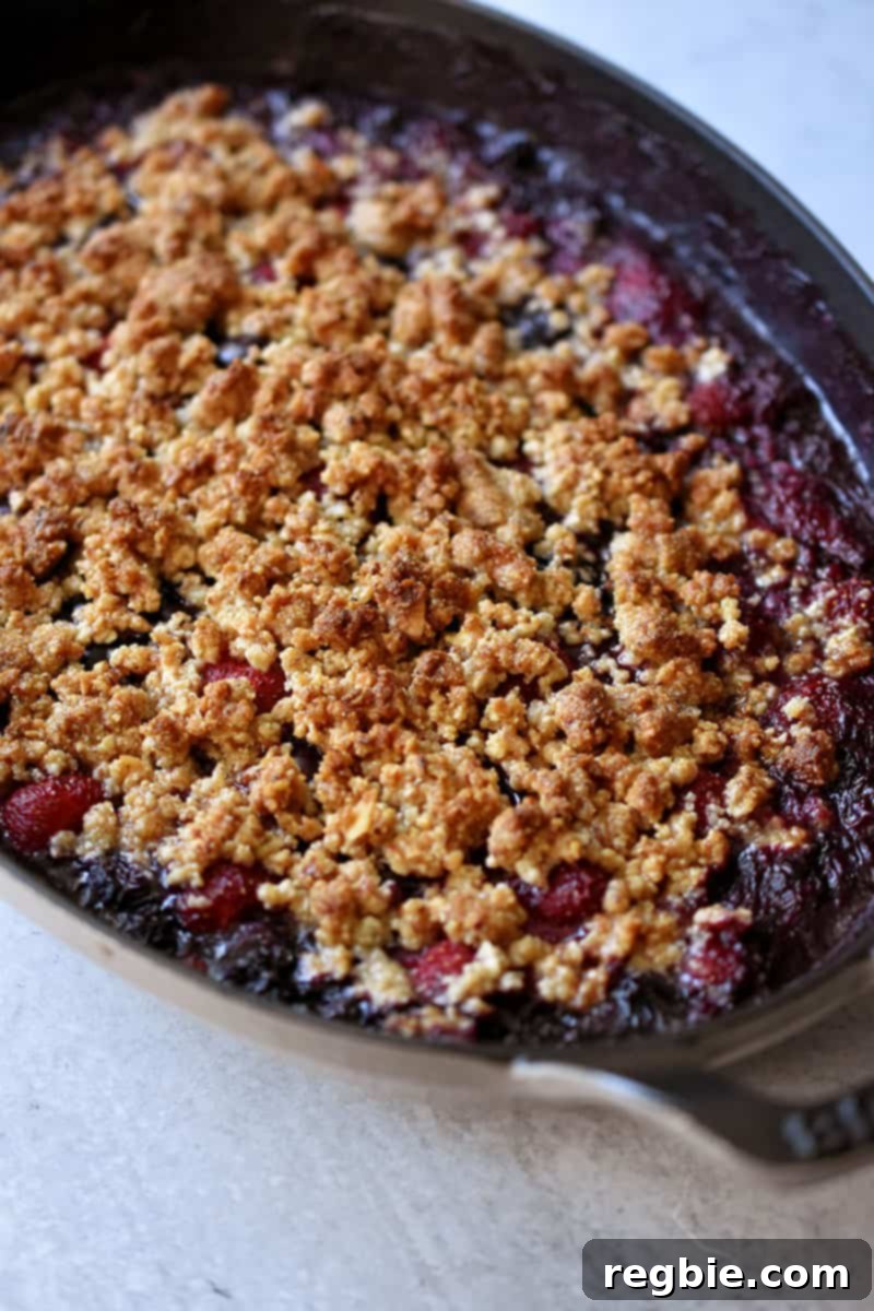 Side shot of a berry crisp right out of the oven.