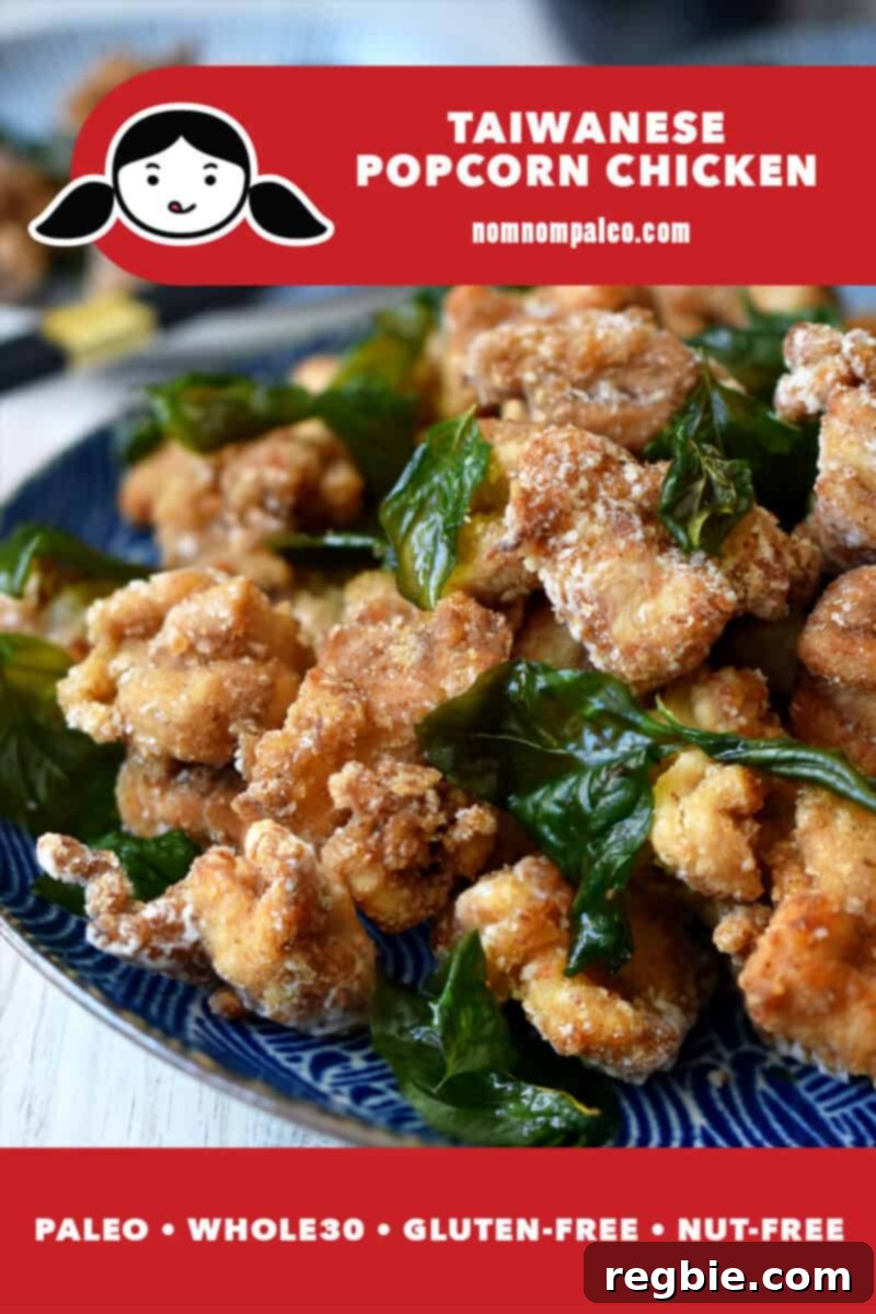 A close up of a platter of Taiwanese Popcorn Chicken with fried basil on a blue plate. A red banner at the bottom reads paleo, Whole30, gluten-free, and nut-free