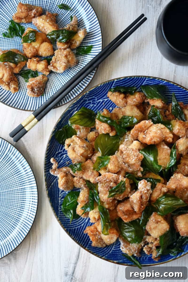 An overhead shot of Taiwanese fried chicken with fried basil.
