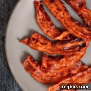 An overhead shot of a brown plate covered with crispy microwave bacon.