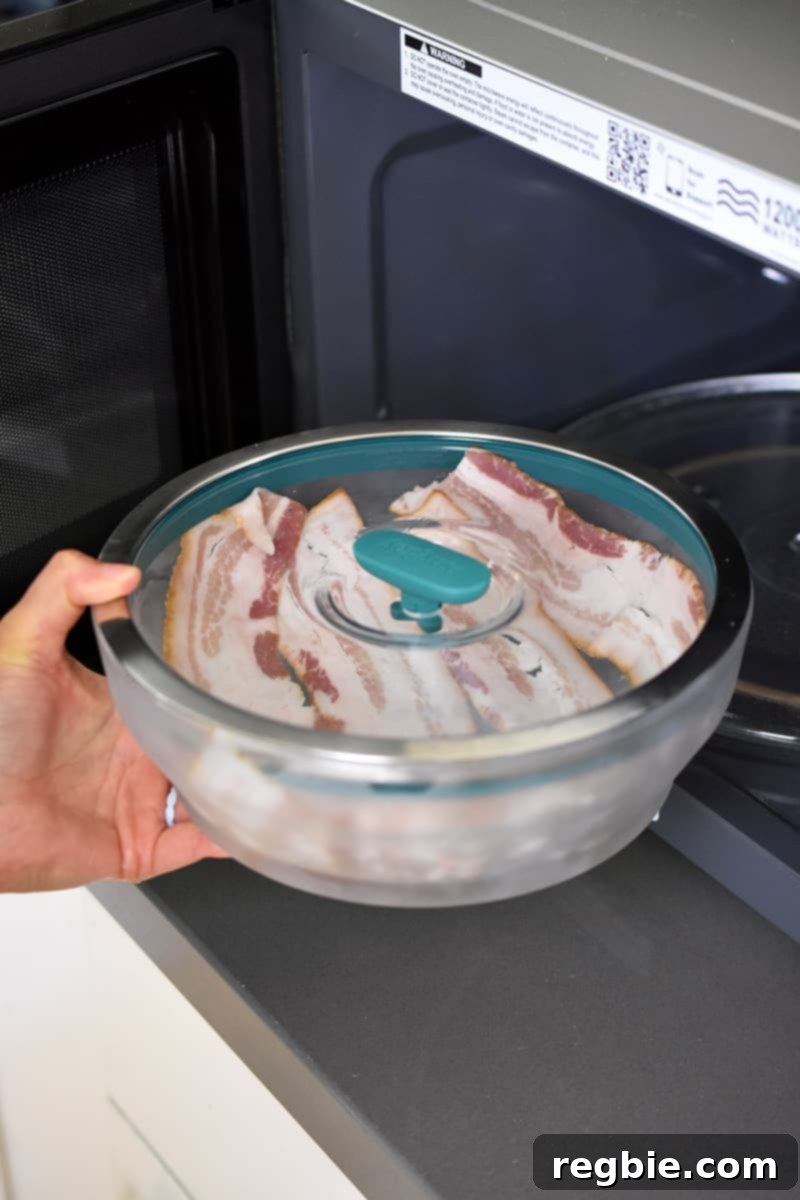 Master Crispy Microwave Bacon: Clean and Waste-Free 7 Placing a closed container of raw bacon into an open microwave
