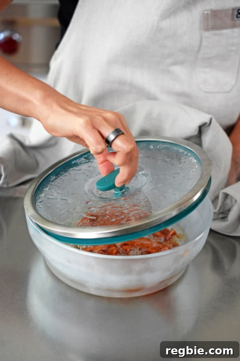 Master Crispy Microwave Bacon: Clean and Waste-Free 8 Opening a container filled with microwaved crispy bacon.