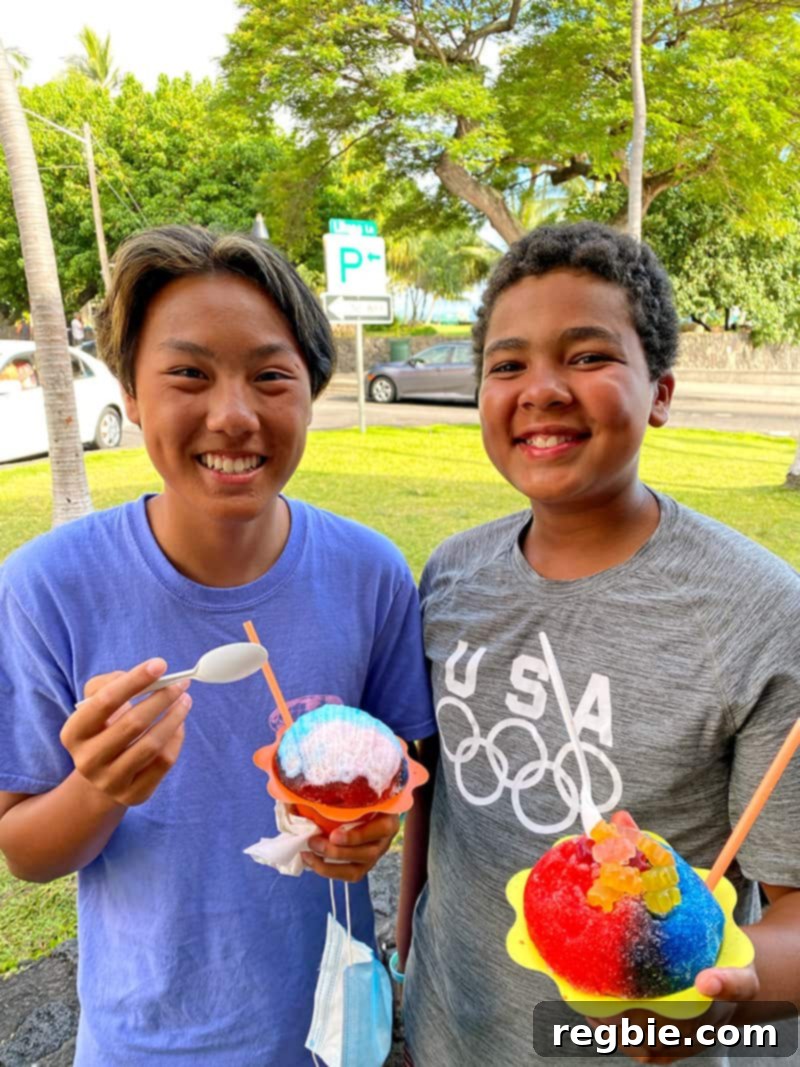 Two smiling teenagers holding shave ice from Scandinavian Shave Ice