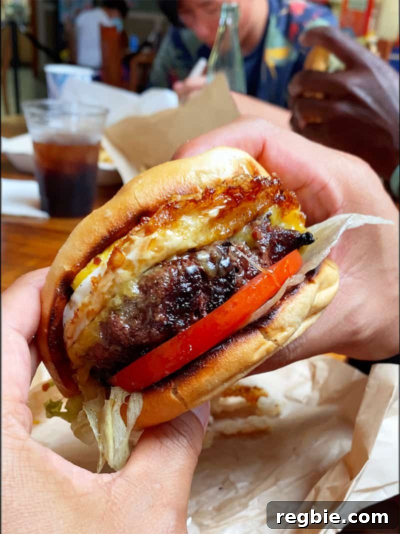 Closeup shot of a gluten-free cheeseburger from Village Burger Kamuela on the Big Island
