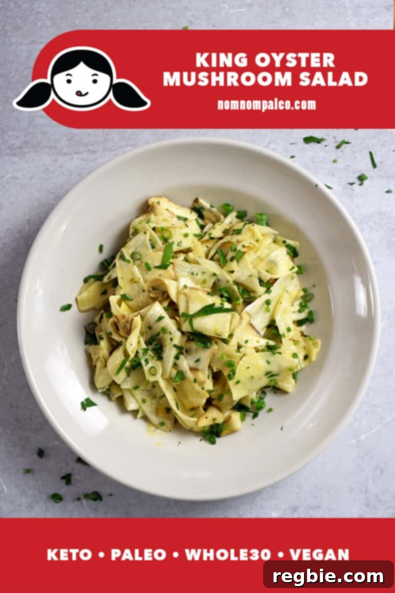 An overhead shot of a bowl with shaved king oyster mushroom salad with fresh herbs on top. The red banner at the bottom says paleo, whole30, vegan, and keto