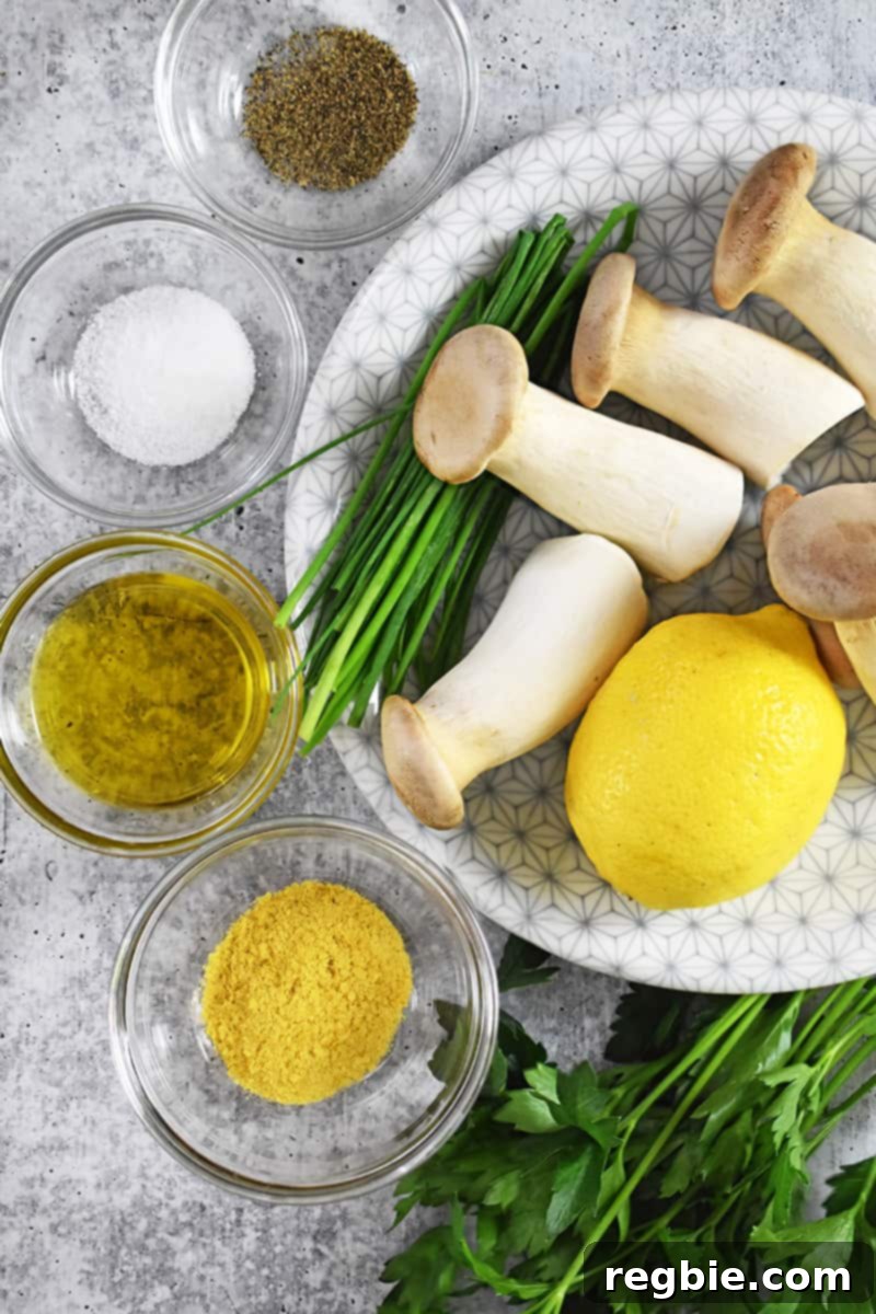 An overhead shot of the ingredients for king oyster mushroom salad: mushrooms, lemon, nutritional yeast, extra virgin olive oil, and salt.