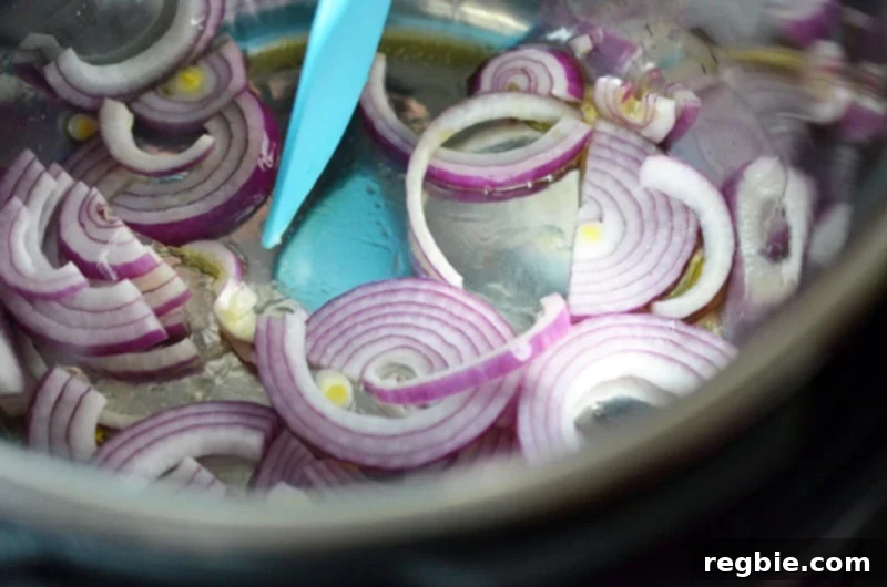 The onions are cooked in the Instant Pot on the Sauté function until perfectly translucent and fragrant.