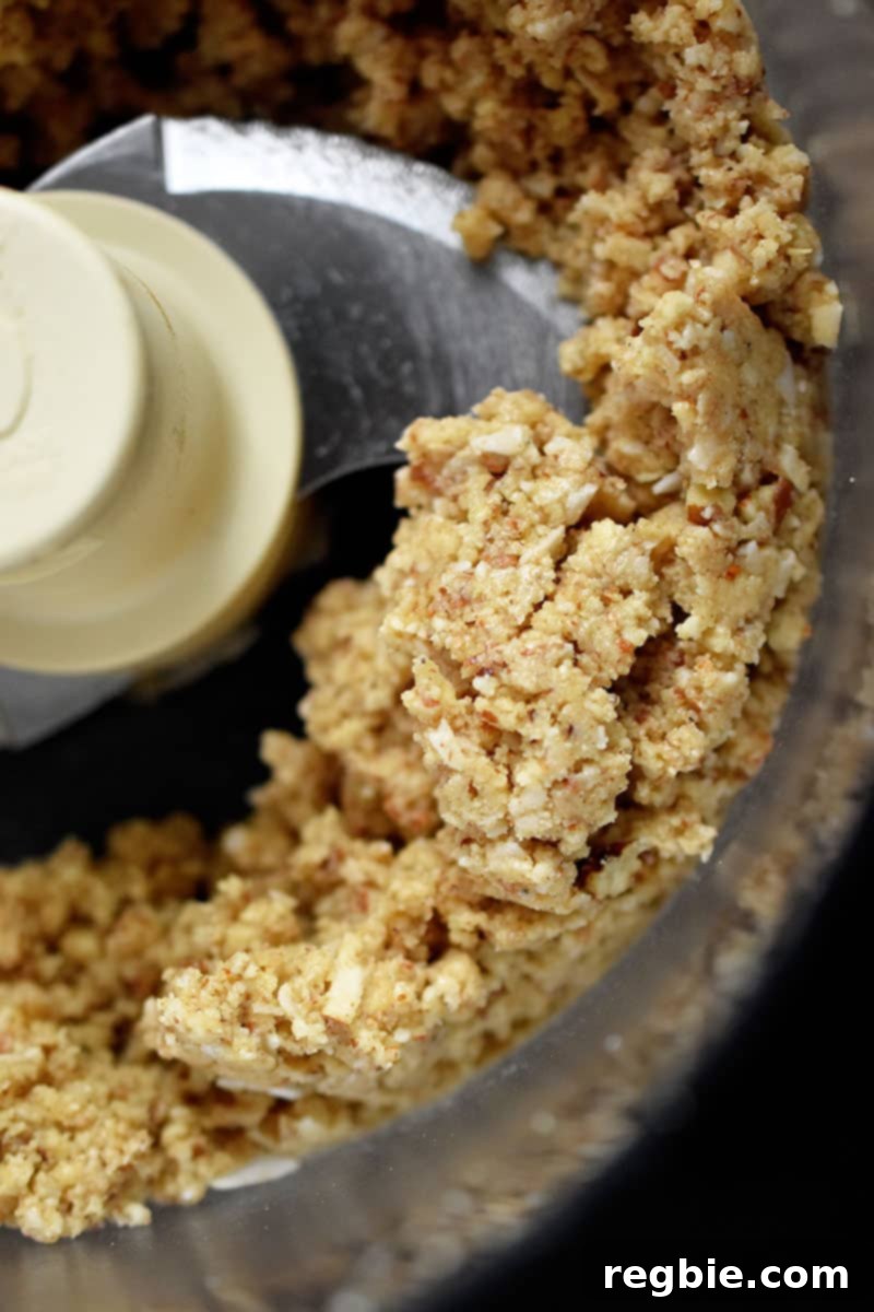 Guilt Free Apple Crisp 11 An overhead shot an open food processor filled with apple crisp topping.